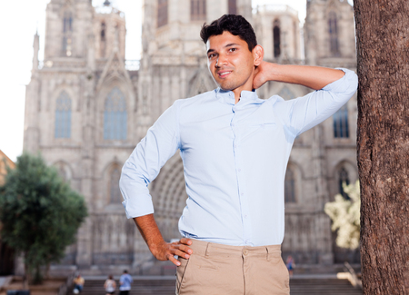 ordinary young European guy in blue shirt walking around cityの写真素材