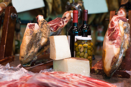 Still life with jerked iberic jammon of bacon with wine, cheese and olivesの写真素材