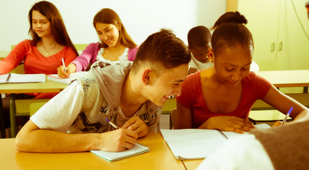 student write off from notebook African-American students in classroomの写真素材