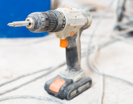 worn dusty screwdriver on the cement floorの写真素材