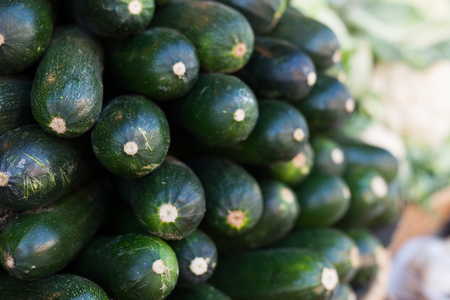 zucchini on market counter in wicker basketの写真素材