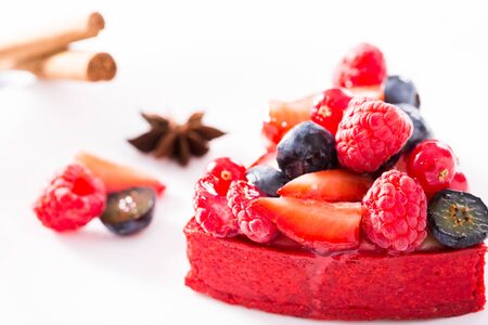 Delicious cake with fresh forest berries with cinnamon and aniseの写真素材