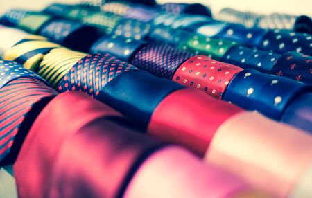 collection of ties on hangers in men clothing storeの写真素材