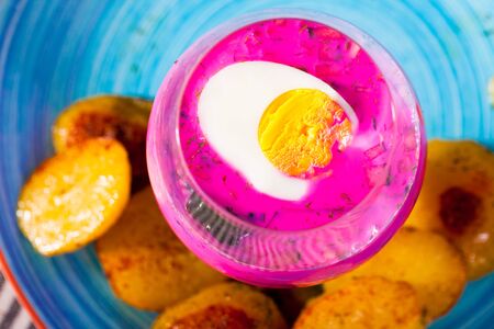 Belarusian cold beet soup in verrin glass serving on plate with fried potatoesの写真素材
