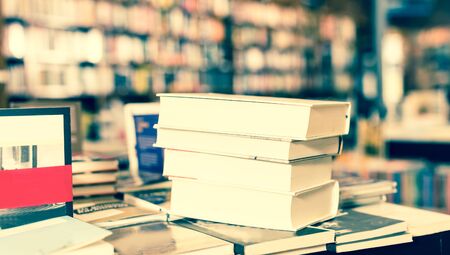 stack of art books lying on table in bookstoreの写真素材
