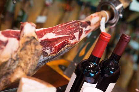 Still life with jerked iberic jammon of bacon with wine, cheese and olives