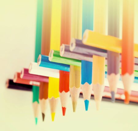 colored pencils stacked in log houseの写真素材