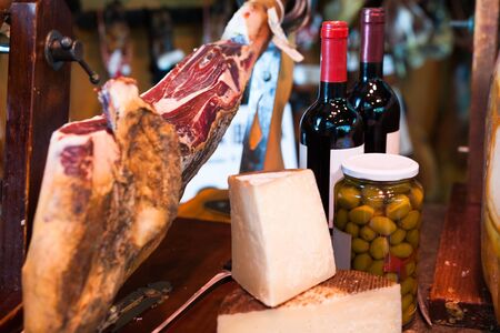 Still life with jerked iberic jammon of bacon with wine, cheese and olivesの写真素材