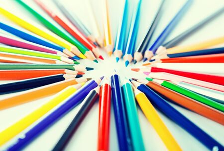 colored pencils lying circle on a white backgroundの写真素材