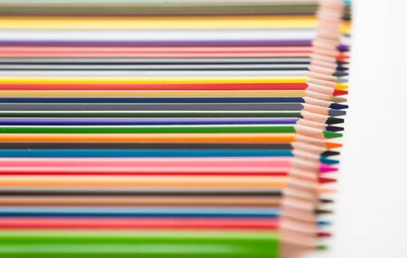 colored pencils lying in row on white backgroundの写真素材