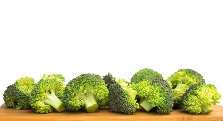 fresh healthy broccoli and florets on wooden boardの写真素材