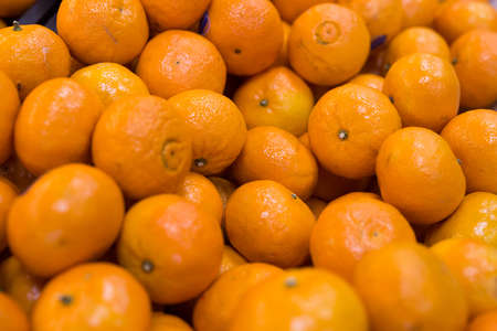 juicy farm mandarins at market counterの写真素材