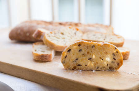 slices of fresh loaf of bread on wooden board
