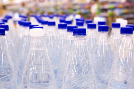 water bottles with blue caps in the supermarketの写真素材