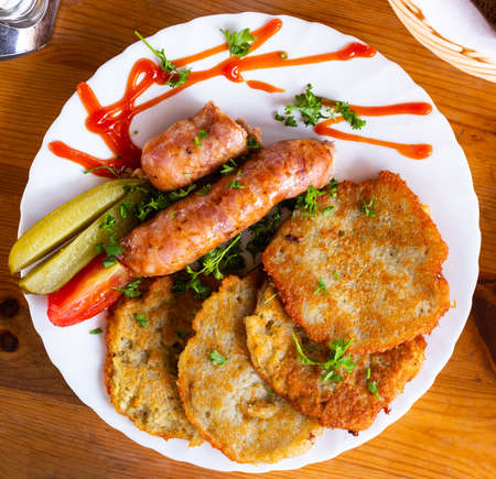 traditional belarusian pancakes with sausages in a restaurantの写真素材