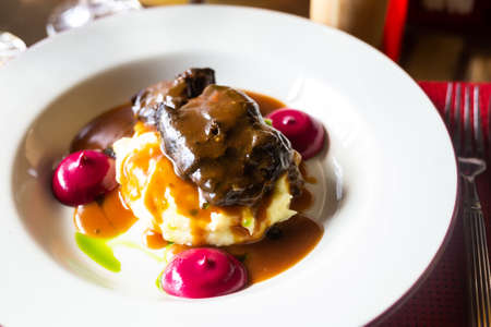 delicious beef cheek with mashed potatoes and currant oilの写真素材