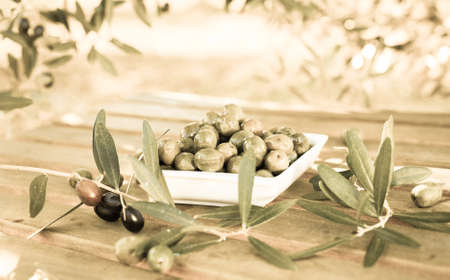 green olives on table in an olive grove