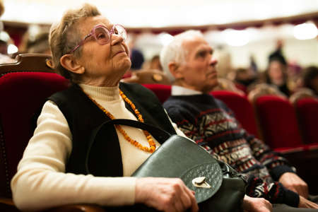 Mature spouses are interested in watching ballet performance in theater hallの写真素材