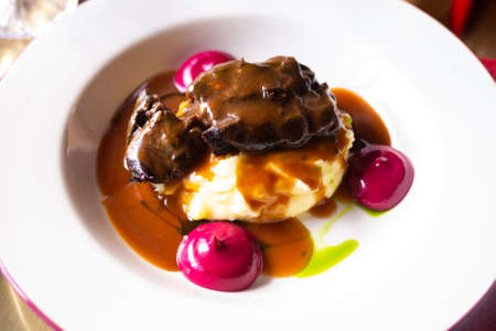 delicious beef cheek with mashed potatoes and currant oilの写真素材