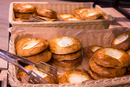 delicious buns with curd filling in baskets in bakeryの写真素材