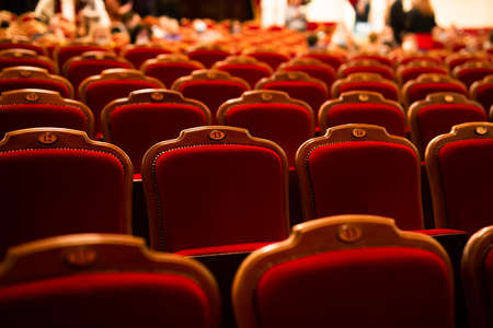 red velvet armchairs in an empty theater hallの写真素材