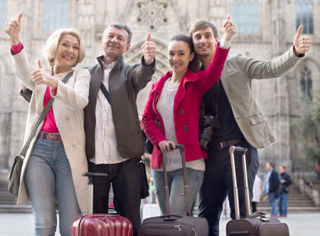 group of tourists of different generations thumb up and smilingの写真素材