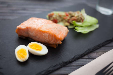 steamed salmon fillet with guacamole homemade and quail eggの写真素材