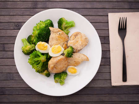 healthy appetizer of chicken pieces with broccoli and quail eggs in bowl for healthy lunchの写真素材