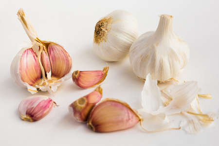 fragrant garlic heads and cloves on white backgroundの写真素材