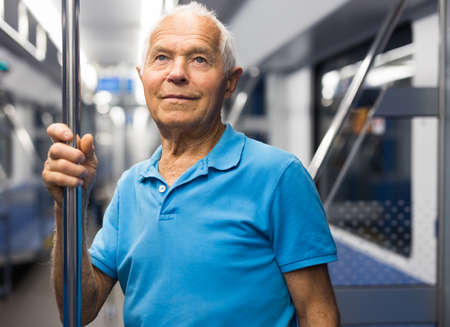Portrait of thoughtful man traveling by modern city subway carの写真素材