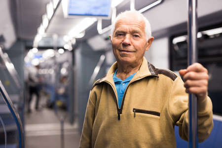 Portrait of mature male passenger riding in a subway wagonの写真素材