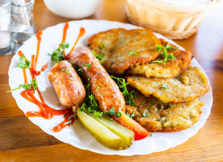 belarusian pancakes with sausages in a restaurantの写真素材