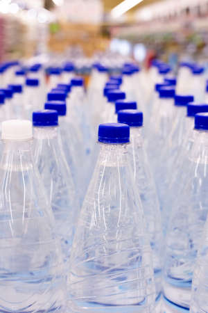 water bottles with blue caps in supermarketの写真素材