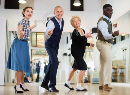 Jazz dancers standing in row and flicking with fingersの写真素材