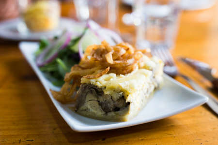 Traditional french pie with bacon and cheese - quiche lorraine, with vegetablesの写真素材