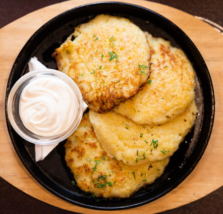 Belarusian cuisine. Potato draniki stew with sour cream