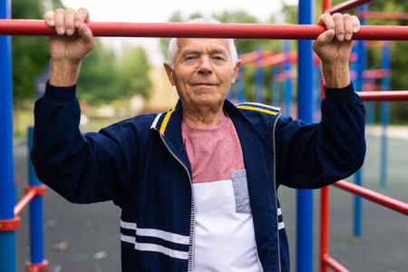 Senior man in outdoor workout stationの写真素材