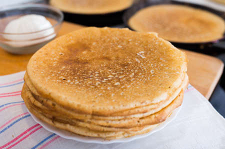 cooking traditional pancakes from wheat flour in the kitchenの写真素材