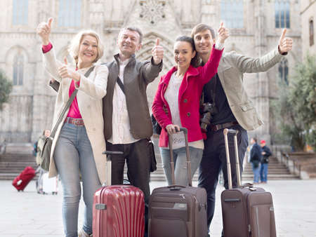 tourists of different generations thumb up and smilingの写真素材