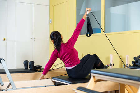 In fitness room. Woman during training on simulatorの写真素材