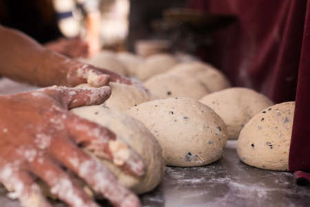 male hands knead yeast dough for baking bread