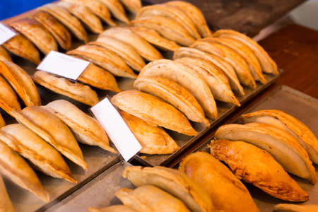freshly baked empanadas with different fillings for saleの写真素材