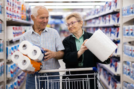 mature couple chooses paper towels in department of supermarketの写真素材