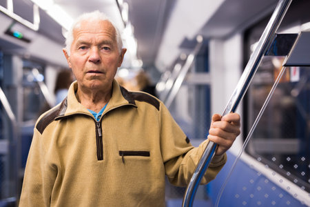 Elderly man in subway trainの写真素材
