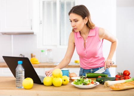 Housewife preparing food in kitchen at homeの写真素材