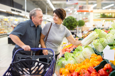 elderly couple chooses china cabbage in vegetable and fruit departmentの写真素材