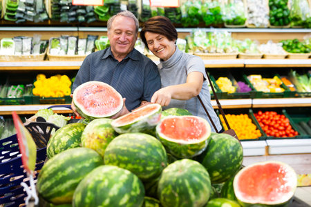 elderly husband and wife choose high-quality watermelonの写真素材