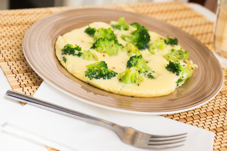 wholesome breakfast. omelet with broccoli on brown plateの写真素材