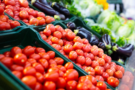 Red fresh tomatoes on a store counterの写真素材