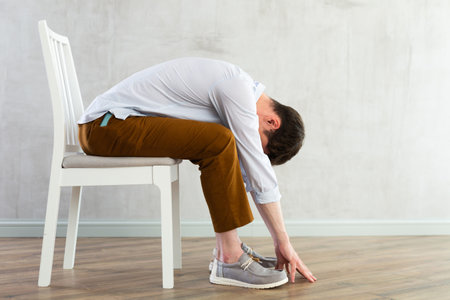 Physical jerks for office workers on chairの写真素材